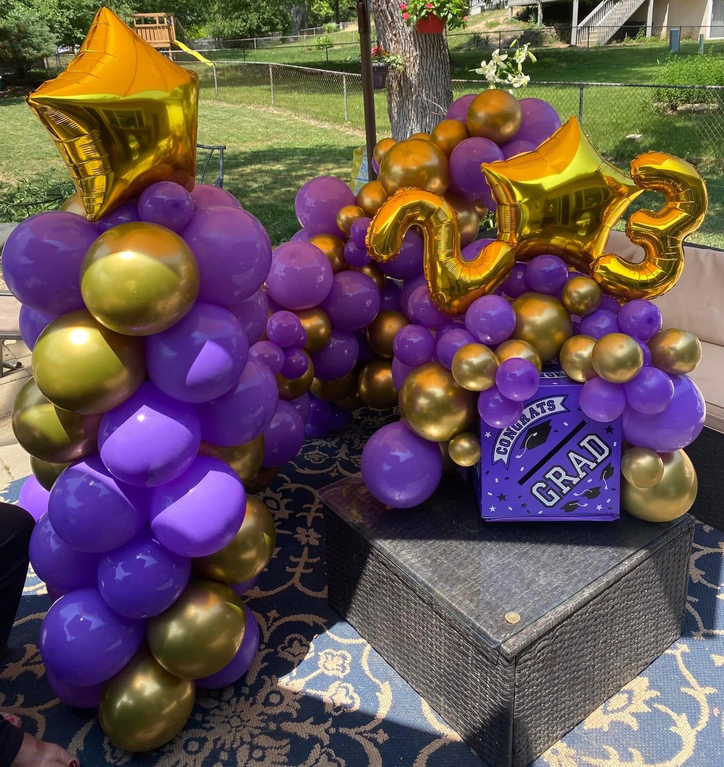 Purple and gold graduation balloon centerpiece with gold 23 number and star balloon